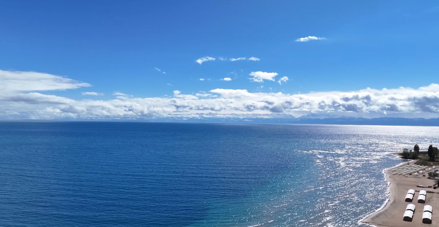 Clear blue water of Issyk Kul near the shore on a sunny summer day 